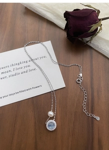 Detail view of S925 sterling silver necklace with freshwater pearl and aquamarine gemstone