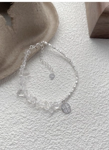 Macro detail of S925 sterling silver bracelet featuring crystal shards and engraved tag