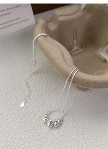 Macro view of S925 sterling silver ball pendant necklace with detailed engraved texture
