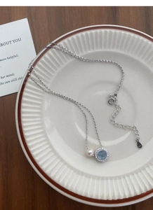 Detail of S925 silver necklace with aquamarine, pearl, and hallmark engraving
