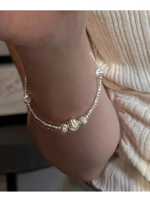 Close-up of S925 sterling silver beaded bracelet with bamboo joints on wrist