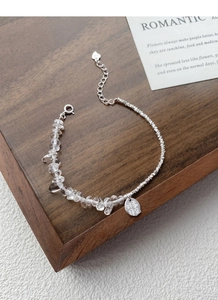 Detail of S925 silver bracelet with white crystal stones and engraved blessing charm