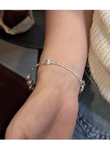 Detailed view of an S925 sterling silver bamboo style beaded bracelet on a woman's wrist