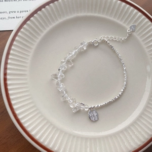 S925 sterling silver bracelet with irregular crystals and Chinese blessing charm on a tray