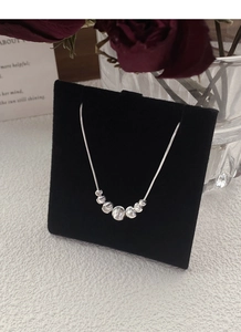 Close-up of S925 sterling silver snake chain necklace with seven polished cat-eye beads