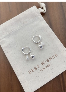 Detailed close-up of 925 sterling silver hoop earrings with detachable pearl and metal drops