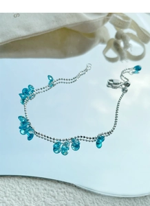 Detail of silver beaded bracelet with sky blue water-drop crystals and lobster clasp