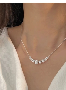 Close-up of elegant S925 sterling silver necklace with seven beads on snake chain