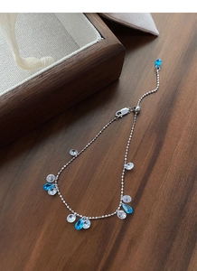 Detailed macro of 925 sterling silver slider bracelet with blue and white teardrop zircons