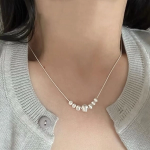 Minimalist S925 sterling silver cat-eye bead necklace worn on neck with snake chain