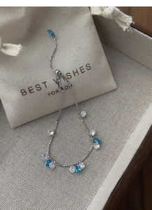 Detail of adjustable silver star river bracelet with blue drop stones and round zircons