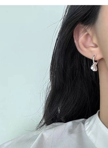 Close-up of S925 sterling silver hoop earrings with double water drop pendants on model