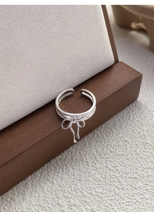 Detailed close-up of S925 sterling silver bow ring with adjustable open band design