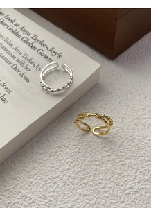 Macro detail of silver and gold double-layered adjustable rings with beads
