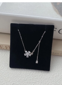 Detailed macro view of S925 silver necklace with zircon flower and butterfly pendant