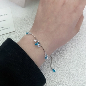 Adjustable 925 sterling silver beaded bracelet with blue teardrop zircon charms on wrist