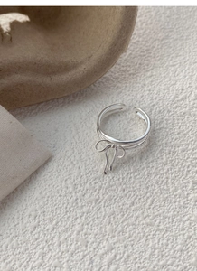Detailed view of S925 silver bow ring with triple bands and adjustable open design