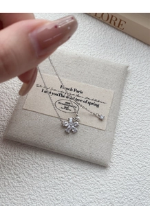Detail of S925 silver flower pendant necklace with cubic zirconia and delicate cable chain