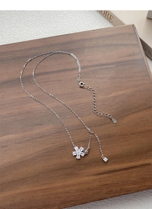 Detailed macro view of S925 sterling silver flower necklace with sparkling zircon crystals
