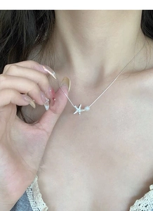 Détail d'un collier en argent S925 avec pendentif étoile de mer et perle blanche ronde