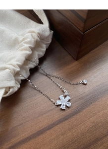 Detailed macro view of S925 silver flower necklace on a premium gift storage box