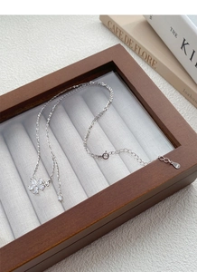Close-up of S925 sterling silver butterfly flower pendant necklace on jewelry display