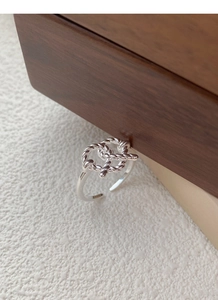 Macro detail of S925 sterling silver twisted rope knot ring with adjustable open band