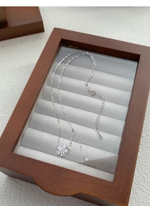 Detail of S925 silver flower pendant with butterfly charm and adjustable O-chain