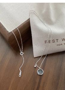 Detailed close-up of S925 sterling silver stamp on the adjustable chain of blue necklace