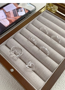 Detail of S925 sterling silver ring set with heart and bow designs in a jewelry box