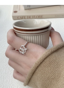 Detail of S925 sterling silver twisted knot ring on hand with elegant lifestyle vibe