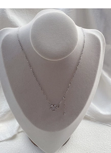 Detail of silver flower pendant with sparkling zircons on elegant display stand