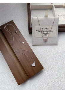 Close-up of S925 sterling silver heart necklaces with micro-pave cubic zirconia crystals