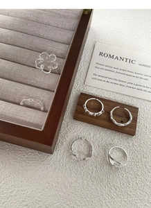 Macro shot of 5pcs S925 sterling silver rings set with floral and bow knot details
