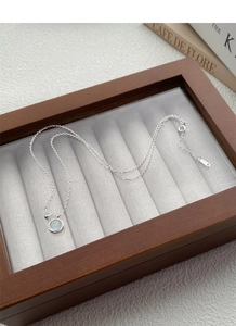 Detail showing S925 sterling silver stamp on the O-chain with light blue gemstone