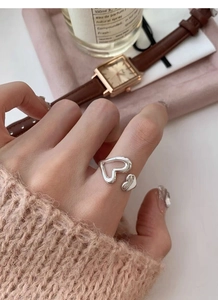 Detailed shot of an S925 sterling silver ring featuring hollow and solid heart designs