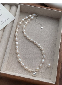 Dettaglio della collana di perle barocche con ciondolo a cuore in argento e marchio S925