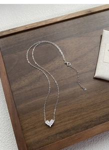 Close-up of S925 sterling silver heart pendant with pavé zircon and hallmark stamp