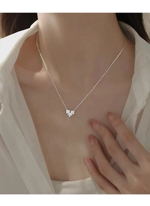 Close-up of S925 sterling silver heart necklace with white zircon pavé on a female neck