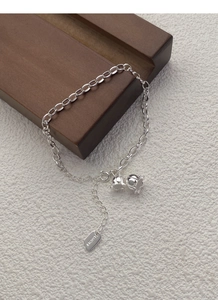 Detail of S925 sterling silver lily of the valley bracelet with lucky square tag
