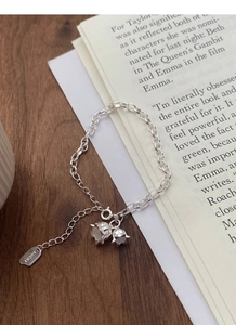 Detail view of S925 silver lily of the valley bracelet with LUCKY engraved square tag