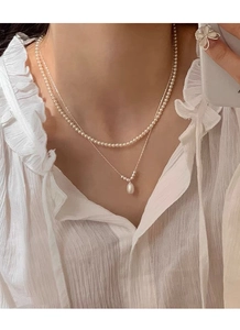 Detail of layered S925 silver necklace with freshwater pearls and water drop pendant