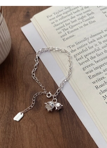 Close-up of S925 silver lily of the valley bracelet with lucky square metal tag