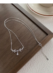 Detailed macro shot of S999 sterling silver wheat necklace with leaf pendant and zircons
