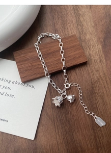 Macro view of S925 sterling silver lily of the valley bracelet with lucky tag