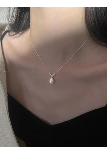 Detail of water drop freshwater pearl pendant on a fine S925 sterling silver chain