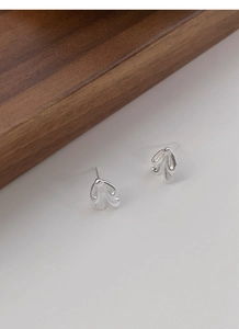 Detail of S925 sterling silver bowknot stud earrings with a polished metallic finish