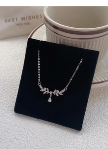 Detailed close-up of S999 sterling silver wheat ear pendant with teardrop zircon stone