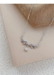 Macro detail of silver wheat ear necklace with sparkling marquise cut zircons