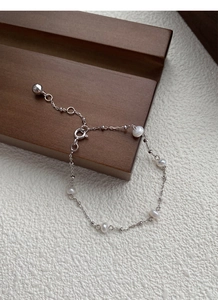 Detailed macro view of S925 sterling silver chain with freshwater pearls and adjustable clasp